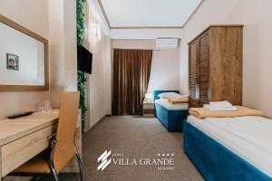 a hotel room with two beds and a desk at HOTEL Villa Grande in Bugojno +137 photos