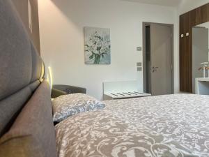 a bedroom with a bed and a painting on the wall at Agordo Suite in Agordo