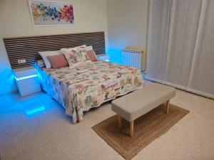 a bedroom with a bed and a bench in it at House TAMARIT PLAYA in Tarragona