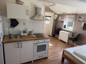 a kitchen with a sink and a counter top at Guest House Stare in Strömstad