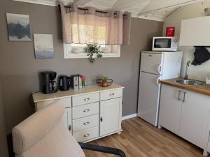 a kitchen with a white refrigerator and a sink at Guest House Stare in Strömstad +5 photos
