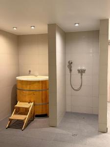 a bathroom with a shower with a wooden barrel and a sink at Apartament Rajka in Biała Woda +48 photos