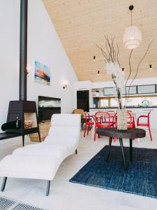a living room with white furniture and a fireplace at Naturelodge Kalbornia Mazury in Dąbrówno