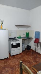 a kitchen with a stove and a refrigerator at Casarao dos Reis in Mosqueiro