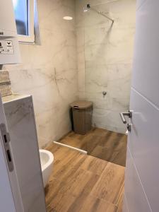 a bathroom with a toilet and a glass shower at Apartment Mey in Sarajevo +41 photos