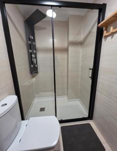 a bathroom with a shower with a white toilet at Atalaia Apartment Foz in Foz +25 photos