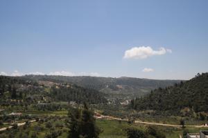 a large cloud in the sky over a valley at دار المكارم للشقق الفندقية الفاخره in Jerash +27 photos