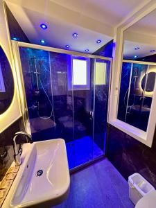 a bathroom with a shower with a white sink and a shower at The Manarola Sea View in Manarola +114 photos