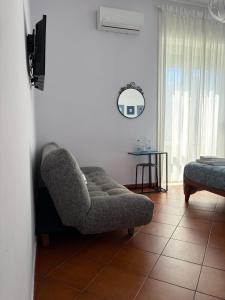 a living room with a chair and a table at B&B il Faro in Salerno
