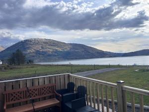 a deck with chairs and a view of a mountain at Dalrigh Pod 2 in Onich