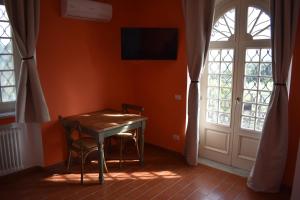 a table and two chairs in a room with a door at Alla Fortezza in Sarzana