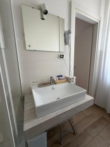 a bathroom with a white sink and a mirror at B&B il Faro in Salerno +84 photos