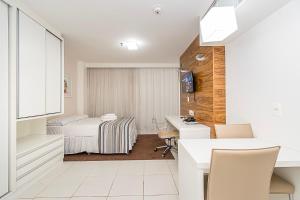 a hotel room with a bed and a desk at Vision Hotel em Brasília 59854 in Brasília