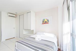 a white bedroom with a bed and a window at Vision Hotel em Brasília 59854 in Brasília