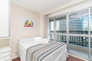 a bedroom with a bed and a large window at Vision Hotel em Brasília 59854 in Brasília