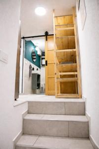 a staircase leading to a bathroom with a wooden door at Apartma Licko in Domžale