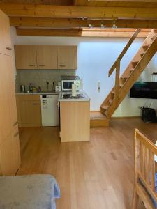 a kitchen with a counter top in a room at Fichtenblockhütte in Sonnenalpe Nassfeld +23 photos