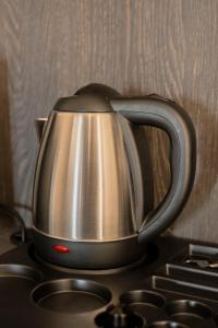 a tea kettle sitting on top of a stove at barneys design apartment in Taranto
