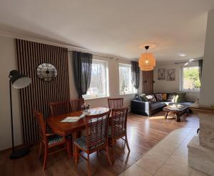 a living room with a table and chairs at Dom w Sąpach in Sąpy