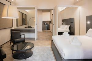 a hotel room with a bed and a table and chair at barneys design apartment in Taranto