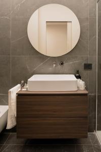 a bathroom with a sink and a mirror at barneys design apartment in Taranto +26 photos