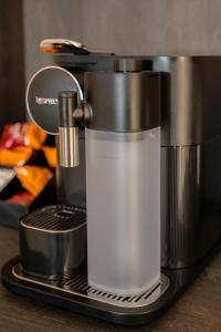 a coffee maker sitting on top of a counter at barneys design apartment in Taranto