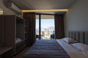 a hotel room with a bed and a view of the city at Giselle Escape in Tirana