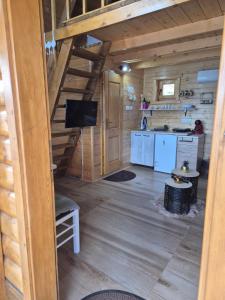a view of a kitchen and a living room in a log cabin at Lake house angela in Kuside