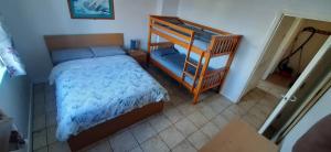 a bedroom with a bunk bed and a staircase at Ocean Bliss in Bundoran