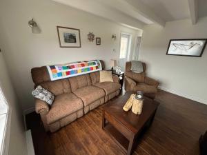 a living room with a couch and a table at Salty B'y & Nook in Twillingate
