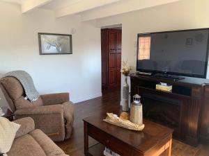 a living room with a large flat screen tv at Salty B'y & Nook in Twillingate