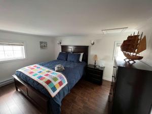 a bedroom with a bed with a quilt on it at Salty B'y & Nook in Twillingate