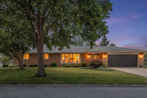a house with a tree in front of it at Stadium District Resch 3 BR Sleeps 8 in Green Bay