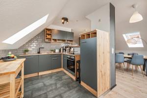 a kitchen with a stainless steel refrigerator and a table at FeWo Dock12C in Kölpinsee +16 photos