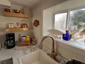 a kitchen counter with a sink and a window at Wild Cove Retreat in Twillingate