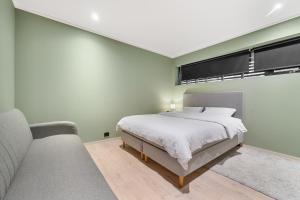 a bedroom with a bed and two couches at Aurora Apartments - Stryn View in Stryn