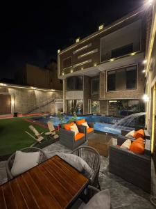 a house with a swimming pool at night at black tiger villa in ‘Ezbet `Abd el-Ḥamîd