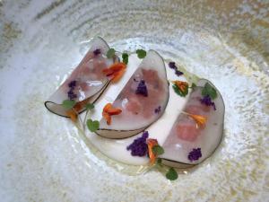a plate with three pieces of food on it at Hôtel Le Sarment d'Or in Riquewihr