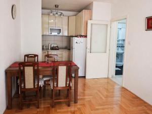 a kitchen with a table and chairs and a refrigerator at Studio Centar in Trebinje