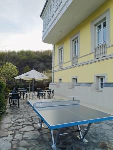 a blue ping pong table in front of a building at Hotel Triacastela in Treacastela