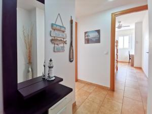 a living room with a black counter and a hallway at Somnis del Delta, Apartamento Deltebre, Delta Ebro in Deltebre +20 photos