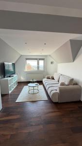 a living room with a couch and a table at Apartament Widok in Nowy Targ