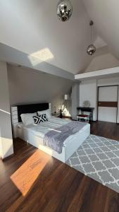 a bedroom with a large bed and a table at Apartament Widok in Nowy Targ