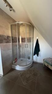 a bathroom with a shower in a attic at Apartament Widok in Nowy Targ +26 photos