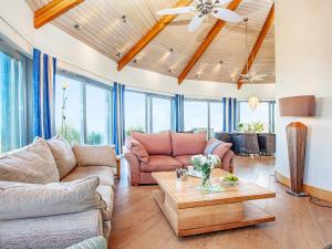 a living room with two couches and a table at Shark Fin in Sennen