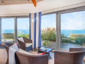 a living room with a view of the ocean at Shark Fin in Sennen