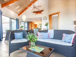 a living room with a couch and chairs and a table at Shark Fin in Sennen