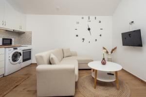 a living room with a couch and a table at Destinys Village II in Zakynthos