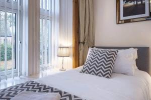 a bedroom with a bed and a large window at Charming & Cosy Drymen Flat in Drymen