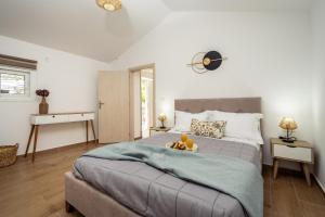 a bedroom with a large bed with two drinks on it at Destinys Village II in Zakynthos